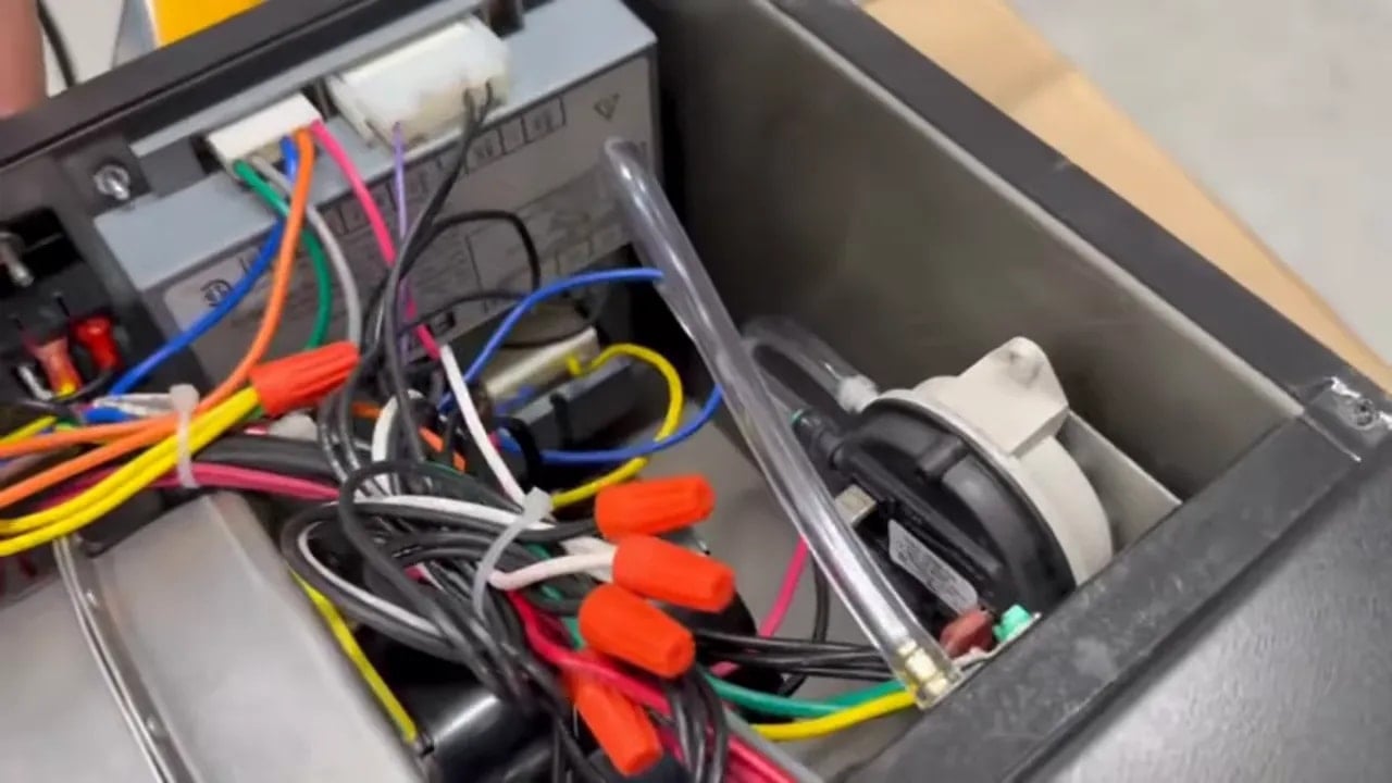 Open V2 burner box showing internal wiring, connectors, and components
